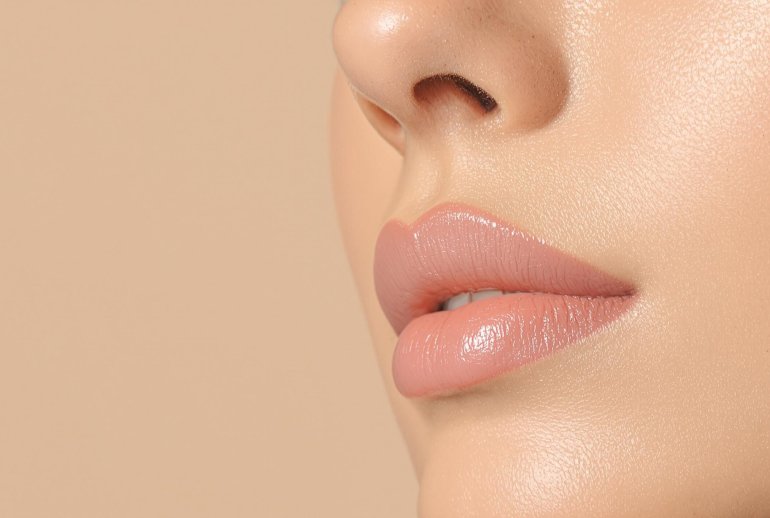 A woman's face with glowing, dewy skin.