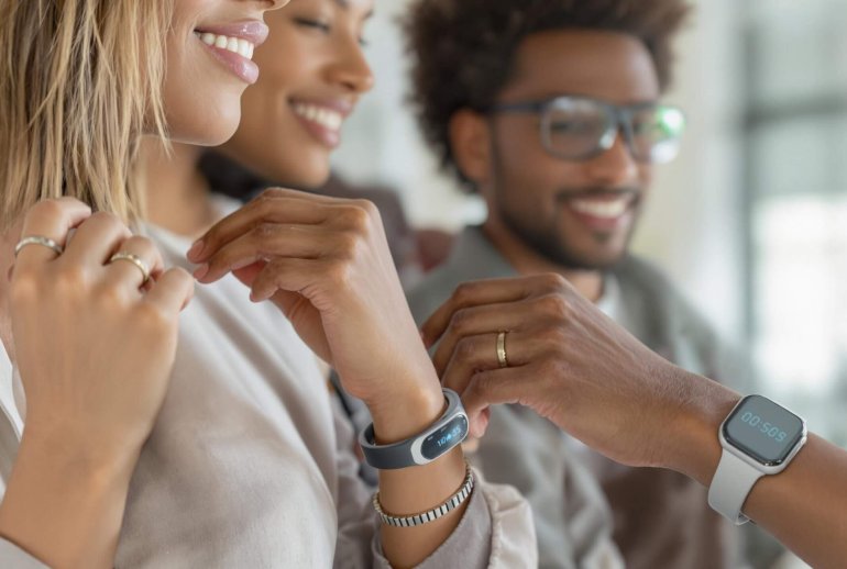 Diverse individuals wearing futuristic wearable tech.