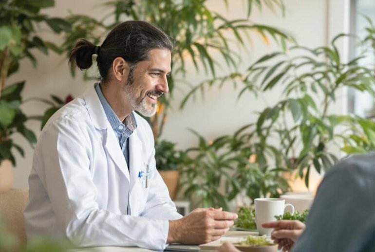 Holistic doctor consulting with a patient in nature.
