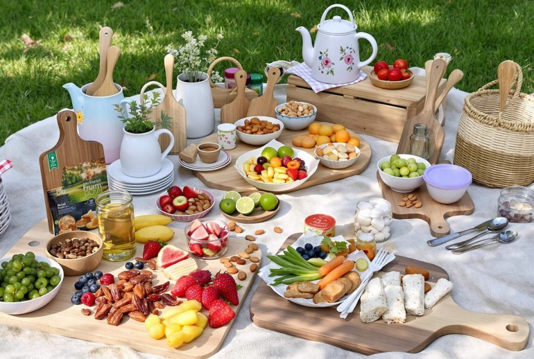 Picnic blanket with natural snacks and eco-friendly items.